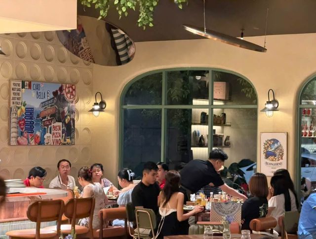 A corner of the dining room with Italian posters, arched windows and a busy table