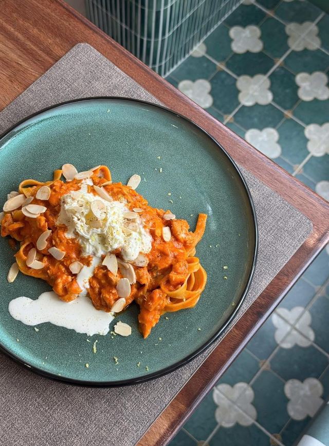 Tagliatelle in creamy tomato sauce topped with burrata and flaked almonds