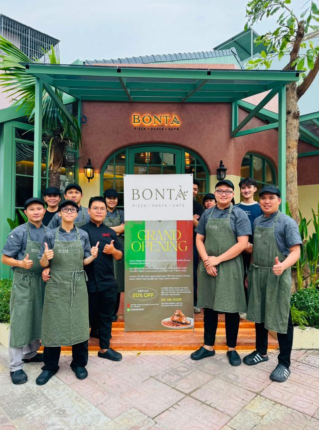 The Bontà team in green aprons giving a thumbs up outside the restaurant on opening day